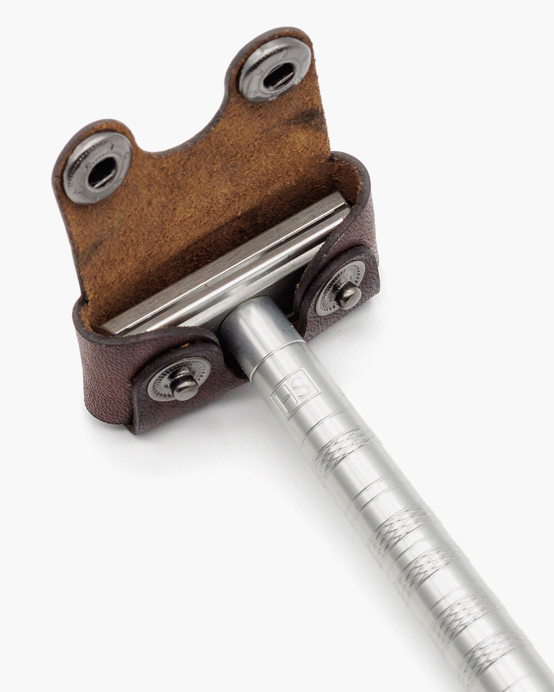 Brown leather head cover on a Henson razor